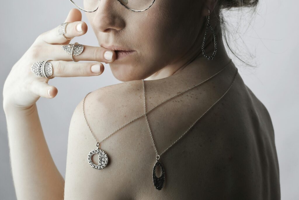 silver necklace stack worn by a woman