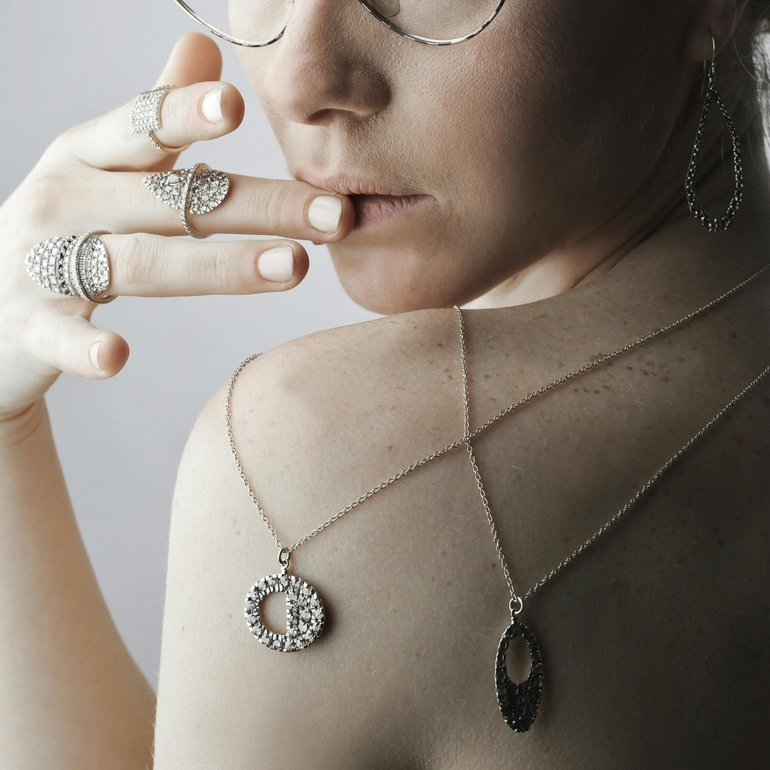 silver necklace stack worn by a woman